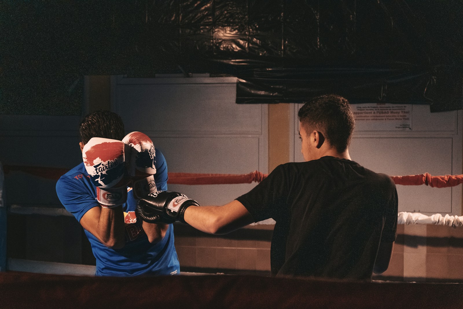 man in black t-shirt and red boxing gloves