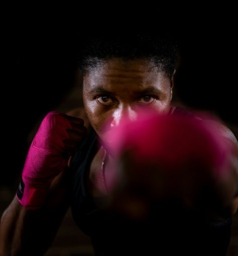 man in black leather jacket holding pink balloon